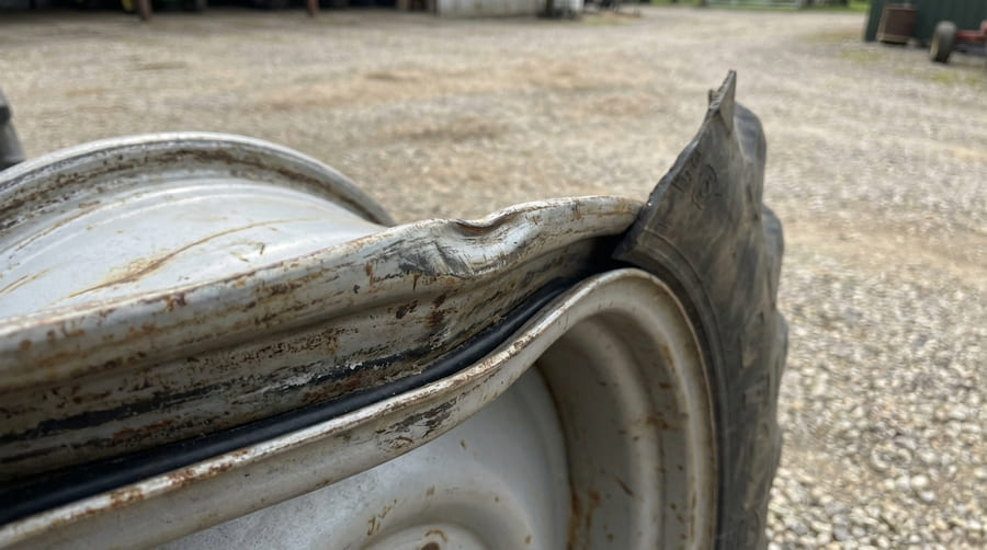 A bent and damaged rim edge, showing a clear point of potential air leakage.