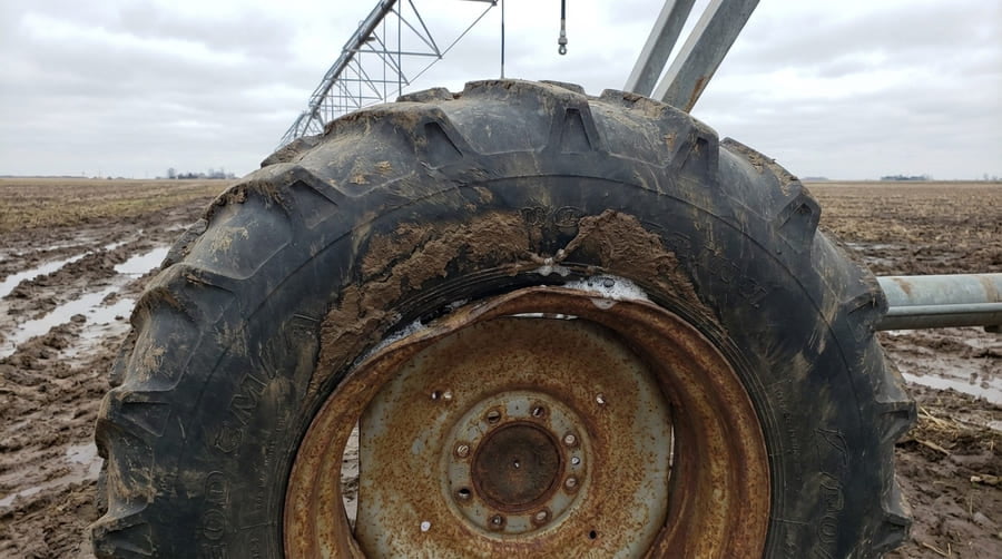 A diagram showing a wide tire incorrectly mounted on a narrow rim, pinching the beads.