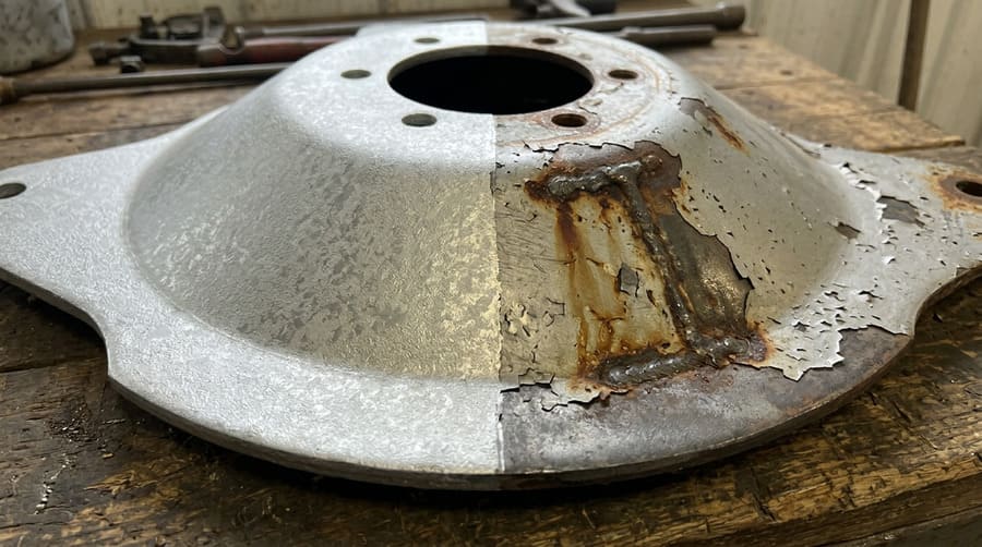 A close-up image comparing a thick, matte HDG coating next to a thin, peeling electro-galvanized coating.